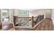 Second-floor view with wooden and metal railing overlooks the living room at 5075 Briarstone Ridge Way, Alpharetta, GA 30022