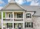 Stunning two-story home with a welcoming porch and meticulously landscaped front yard at 5075 Briarstone Ridge Way, Alpharetta, GA 30022