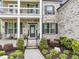An inviting front entrance with a meticulously landscaped garden and covered porch at 5075 Briarstone Ridge Way, Alpharetta, GA 30022
