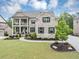 Charming two-story brick home featuring a landscaped lawn, covered porch and a two-car garage at 5075 Briarstone Ridge Way, Alpharetta, GA 30022