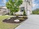A well-maintained front yard featuring professionally manicured landscaping and beautiful curb appeal at 5075 Briarstone Ridge Way, Alpharetta, GA 30022