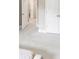 Bright hallway with white doors and neutral carpeting at 5075 Briarstone Ridge Way, Alpharetta, GA 30022