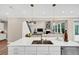 Bright kitchen with quartz counters, island with seating and stainless steel appliances at 5075 Briarstone Ridge Way, Alpharetta, GA 30022