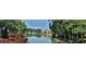 Scenic lake view surrounded by mature trees and lush landscape in a beautiful community at 5075 Briarstone Ridge Way, Alpharetta, GA 30022