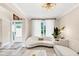 Bright living area showcasing white sofas, plush rug, and ample natural light from the window at 5075 Briarstone Ridge Way, Alpharetta, GA 30022
