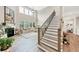 Elegant living room with soaring ceilings, large windows, and a staircase at 5075 Briarstone Ridge Way, Alpharetta, GA 30022