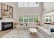 Cozy living room featuring a fireplace, tall windows, and comfortable seating at 5075 Briarstone Ridge Way, Alpharetta, GA 30022