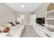 Bright living room featuring a comfortable sectional sofa and modern entertainment center at 5075 Briarstone Ridge Way, Alpharetta, GA 30022