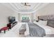 Luxurious main bedroom suite featuring a tray ceiling and comfortable sitting area at 5075 Briarstone Ridge Way, Alpharetta, GA 30022