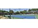 Community tennis courts with lighting, seating, and covered viewing area at 5075 Briarstone Ridge Way, Alpharetta, GA 30022