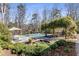 Beautiful backyard featuring a pool, pond, dining area, and lush landscaping at 2109 Rugby Ave, Atlanta, GA 30337