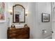 Charming powder room with a vessel sink atop an antique wooden dresser and decorative sconces at 2109 Rugby Ave, Atlanta, GA 30337