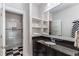 Elegant bathroom featuring black granite counters and a walk-in shower with decorative black-and-white tiles at 2109 Rugby Ave, Atlanta, GA 30337