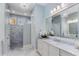 Elegant bathroom featuring marble shower, granite countertops and custom lighting at 2109 Rugby Ave, Atlanta, GA 30337