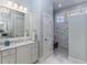 Elegant bathroom featuring marble shower, granite countertops and custom lighting at 2109 Rugby Ave, Atlanta, GA 30337