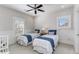 Bright bedroom with two twin beds, shuttered windows, decorative molding, and a cozy atmosphere at 2109 Rugby Ave, Atlanta, GA 30337