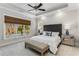 This primary bedroom boasts tray ceilings, large windows and natural light, plus designer window coverings at 2109 Rugby Ave, Atlanta, GA 30337