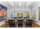 Elegant dining room with a rustic wooden table, chandelier, and view of the backyard at 2109 Rugby Ave, Atlanta, GA 30337