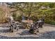 Outdoor stone fire pit surrounded by Adirondack chairs, creating an inviting gathering spot at 2109 Rugby Ave, Atlanta, GA 30337