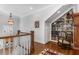 Bright hallway featuring a built-in bookshelf, hardwood floors, and a decorative Persian rug at 2109 Rugby Ave, Atlanta, GA 30337