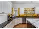 Well-lit kitchen featuring custom cabinets, stainless steel appliances, and open shelving at 2109 Rugby Ave, Atlanta, GA 30337