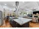 Open concept kitchen with center island flowing into dining and living areas with a fireplace at 2109 Rugby Ave, Atlanta, GA 30337