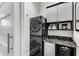 Efficient laundry room with stacked washer and dryer, countertop, and storage at 2109 Rugby Ave, Atlanta, GA 30337