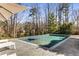 Inviting backyard pool with a spa and stamped concrete deck, surrounded by lush greenery at 2109 Rugby Ave, Atlanta, GA 30337