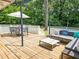Outdoor entertaining space includes deck with lights, outdoor seating and white fence at 2413 Hunting Valley Dr, Decatur, GA 30033