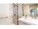 Well-lit bathroom offers a marble-tiled shower, single vanity, and updated fixtures at 2413 Hunting Valley Dr, Decatur, GA 30033
