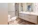 Clean, well-lit bathroom with dual sinks, marble style tile shower with glass door at 2413 Hunting Valley Dr, Decatur, GA 30033