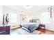 Comfortable bedroom with accent wall, rug, and window with mini blinds at 2413 Hunting Valley Dr, Decatur, GA 30033