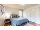 Comfortable bedroom with accent wall, rug, and window with mini blinds at 2413 Hunting Valley Dr, Decatur, GA 30033