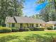 Charming single-story home with well-manicured lawn, mature shrubs, and covered parking at 2413 Hunting Valley Dr, Decatur, GA 30033