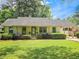 Charming single-story home with well-manicured lawn, mature shrubs, and covered parking at 2413 Hunting Valley Dr, Decatur, GA 30033