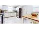 Well-lit kitchen with white cabinetry, stainless appliances, and an island with seating at 2413 Hunting Valley Dr, Decatur, GA 30033