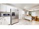 Open kitchen and dining area, featuring stainless steel appliances and white cabinetry at 2413 Hunting Valley Dr, Decatur, GA 30033