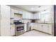 Stylish kitchen featuring white cabinets, stainless steel appliances, and a tiled backsplash at 2413 Hunting Valley Dr, Decatur, GA 30033