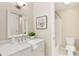 Bright bathroom featuring a marble countertop vanity with a shower-tub combo and modern toilet at 6185 Deerwoods Trl, Alpharetta, GA 30005