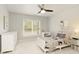 Cozy bedroom with bright window, ceiling fan, white furnishings and decor, and soft carpet at 6185 Deerwoods Trl, Alpharetta, GA 30005