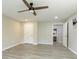 Simple bedroom with fan, gray walls, and doorway to a bathroom at 6185 Deerwoods Trl, Alpharetta, GA 30005