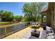 An expansive deck with views of a pond, featuring seating and outdoor living space at 6185 Deerwoods Trl, Alpharetta, GA 30005