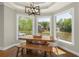 Dining area with beautiful windows overlooking a serene backyard and a waterfront view at 6185 Deerwoods Trl, Alpharetta, GA 30005