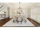 Elegant dining room with tray ceilings, large windows, and stylish chandelier at 6185 Deerwoods Trl, Alpharetta, GA 30005