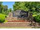 Stone entrance sign reading Deer Lake with manicured landscaping at 6185 Deerwoods Trl, Alpharetta, GA 30005