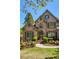 Charming brick facade of the home complemented by lush landscaping at 6185 Deerwoods Trl, Alpharetta, GA 30005