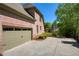 Brick home featuring an attached garage, long driveway, and landscaped yard with serene lake views at 6185 Deerwoods Trl, Alpharetta, GA 30005
