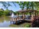 Gazebo on a lake with a fountain and seating at 6185 Deerwoods Trl, Alpharetta, GA 30005
