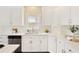 Bright kitchen with stainless steel appliances, white cabinets, subway tile backsplash, and an island at 6185 Deerwoods Trl, Alpharetta, GA 30005
