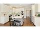 Beautiful kitchen with an island, stainless appliances, hardwood floors, and ample cabinet space at 6185 Deerwoods Trl, Alpharetta, GA 30005